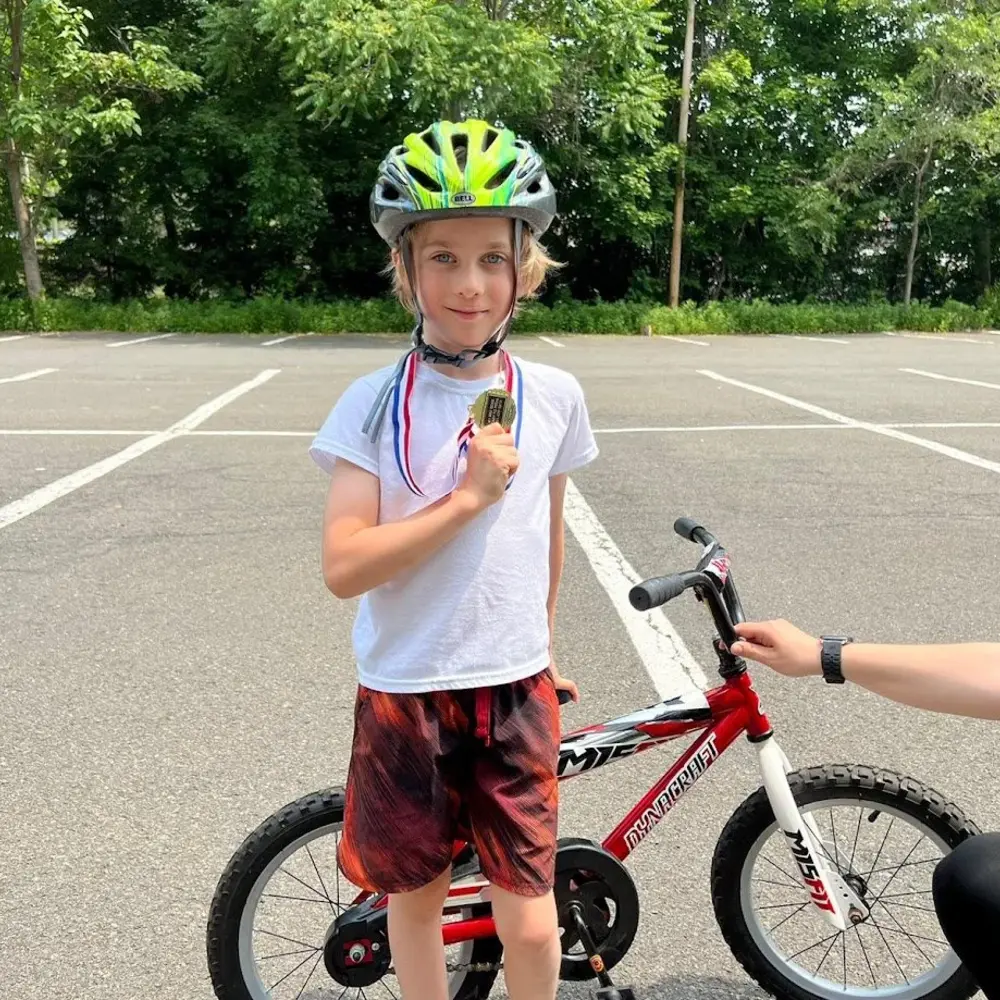 A proud child riding after a Ready to Pedal lesson